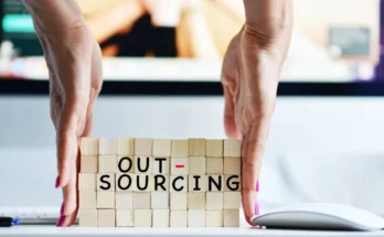 Entrepreneur evaluating outsourcing options for business growth