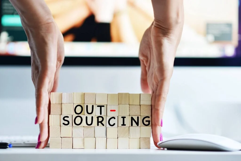 Entrepreneur evaluating outsourcing options for business growth