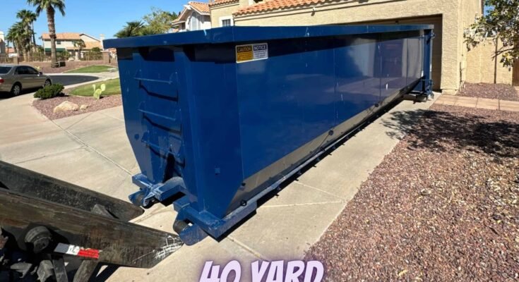 A large dumpster placed on a residential driveway in Phoenix, ready for cleanup and waste disposal.