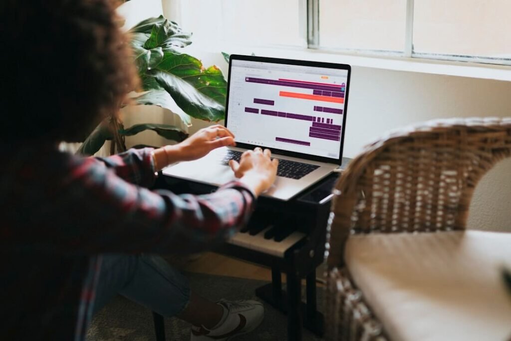 A woman at a desk using a laptop and keyboard, focused on AI-powered knowledge management for better decision-making.