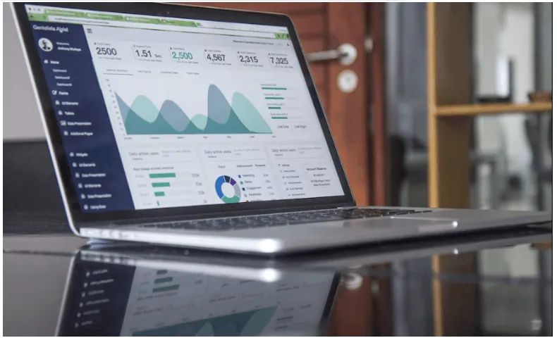 A computer displays several data visualizations