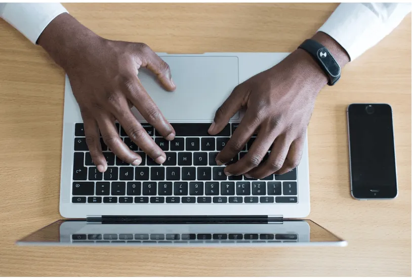 An Overhead View Of Someone Typing On A Laptop And Learning More About Buying Intent